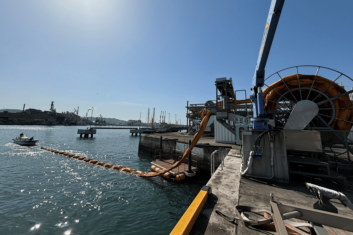 photo: Installation of oil fence Drill at the Pier (Mizushima Plant)